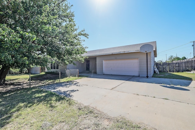 ranch-style home with a front lawn and a garage