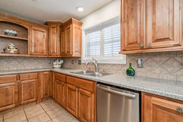 kitchen featuring light tile patterned flooring, a sink, light countertops, and stainless steel dishwasher