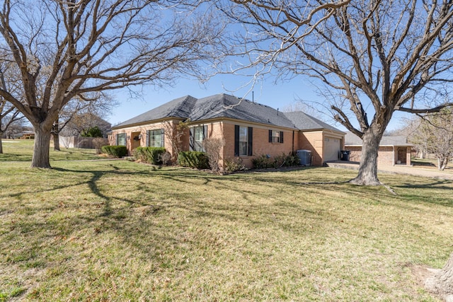 view of property exterior featuring brick siding, central AC unit, an attached garage, and a yard