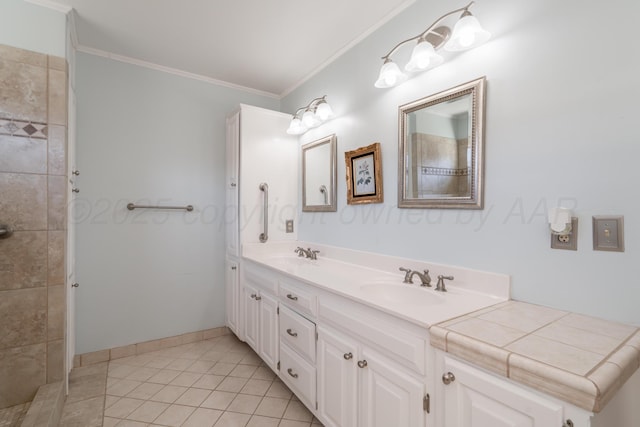 full bath featuring double vanity, tile patterned flooring, crown molding, and a sink