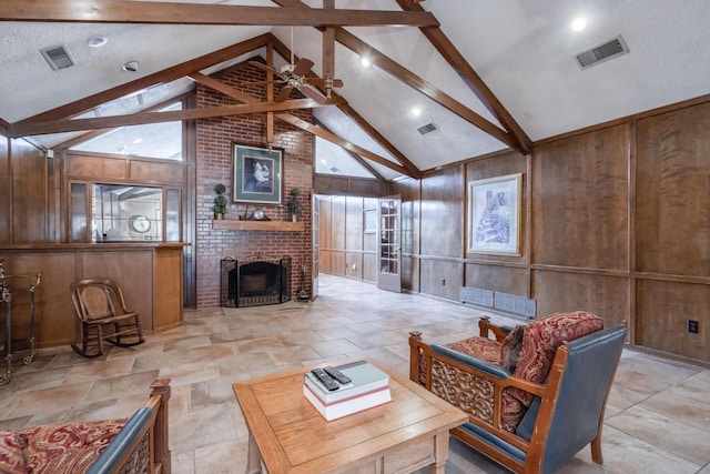 living room featuring visible vents, beam ceiling, and wooden walls