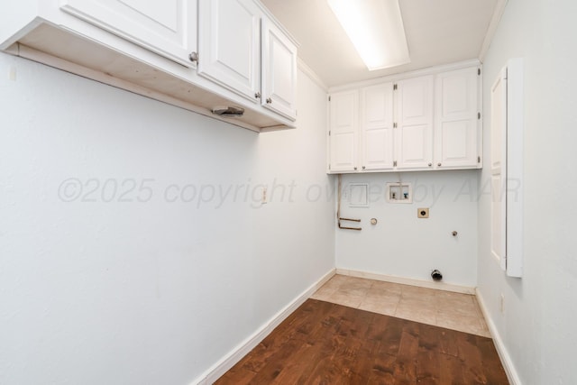 laundry area with hookup for a washing machine, wood finished floors, gas dryer hookup, cabinet space, and electric dryer hookup