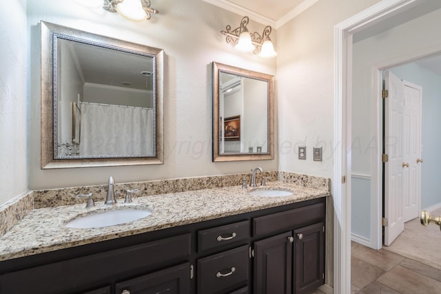 full bath featuring a sink, double vanity, and crown molding