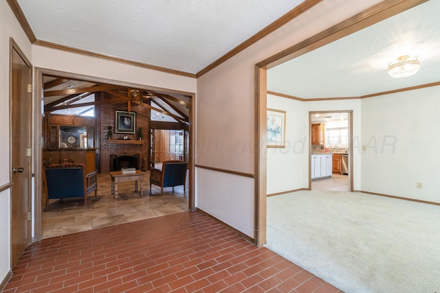 interior space with a brick fireplace, crown molding, and baseboards