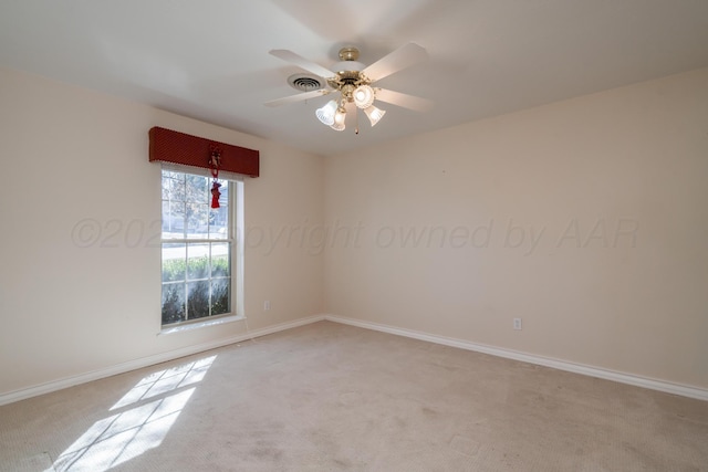 empty room with a ceiling fan, baseboards, visible vents, and light carpet