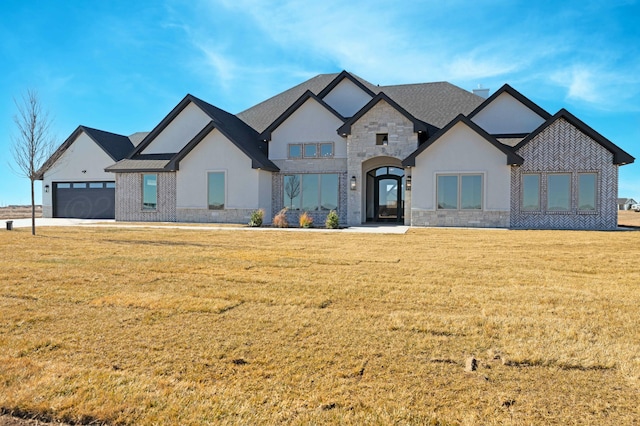 view of front of home with a garage and a front lawn