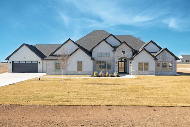 french country inspired facade featuring a garage and a front yard