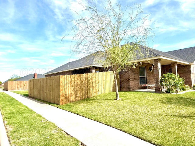 8101 Vail Dr, Amarillo, TX 79118 - view of side of property featuring brick siding and roof with shingles