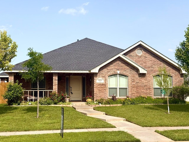 8101 Vail Dr, Amarillo, TX 79118 - ranch-style home with brick siding, roof with shingles, and a front lawn