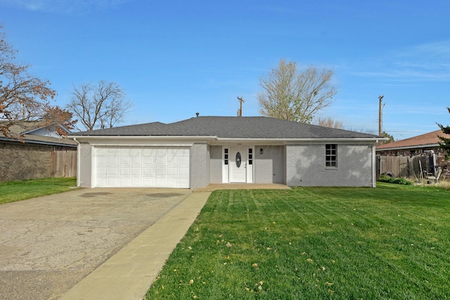 ranch-style house featuring a front yard and a garage