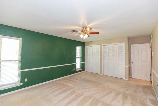 5404 While A Way Rd, Amarillo, TX 79109 - unfurnished bedroom featuring multiple closets, baseboards, carpet flooring, and a ceiling fan