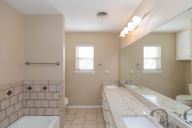 5404 While A Way Rd, Amarillo, TX 79109 - full bathroom featuring toilet, double vanity, a bath, and plenty of natural light