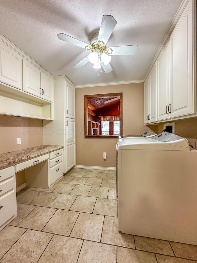 interior space featuring ceiling fan, independent washer and dryer, built in desk, a textured ceiling, and white cabinets