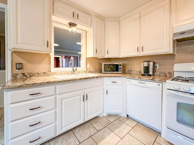 kitchen featuring white cabinetry, sink, white appliances, and light stone counters