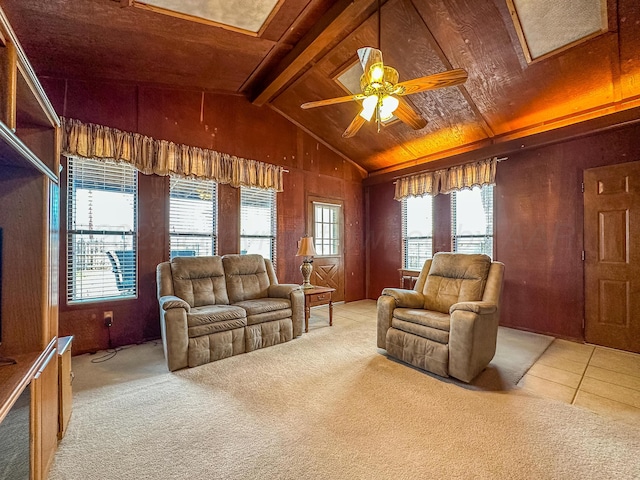 living room featuring a wealth of natural light, light colored carpet, lofted ceiling with beams, and ceiling fan