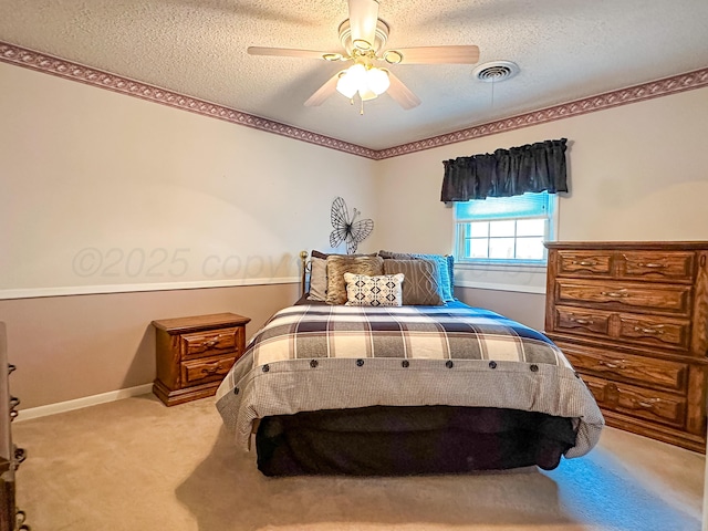 bedroom featuring ceiling fan, carpet flooring, and a textured ceiling