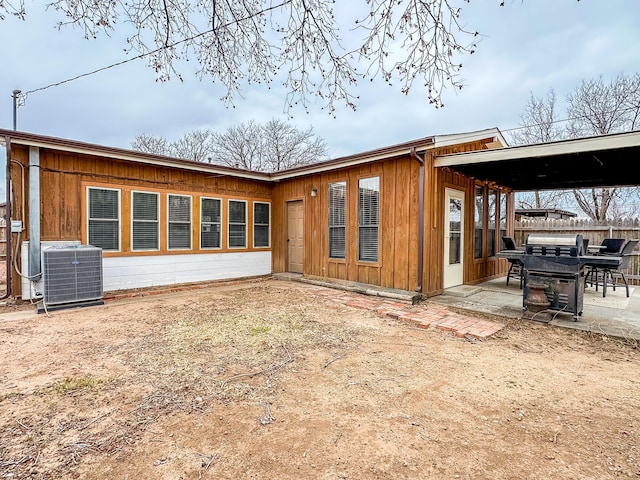 back of property with cooling unit and a patio