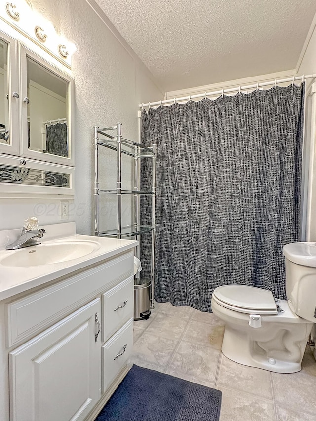 bathroom with vanity, a textured ceiling, tile patterned floors, toilet, and walk in shower