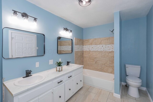 bathroom featuring a bath, toilet, and vanity