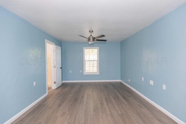 spare room with wood-type flooring and ceiling fan