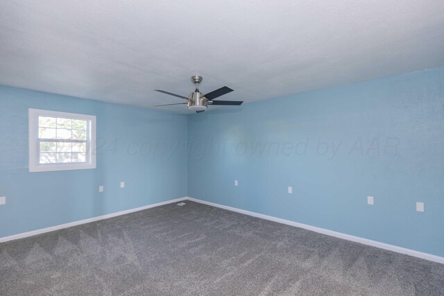 carpeted spare room with a textured ceiling and ceiling fan