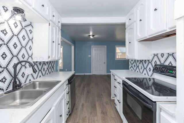 kitchen with white cabinets, sink, dark wood-type flooring, and electric stove