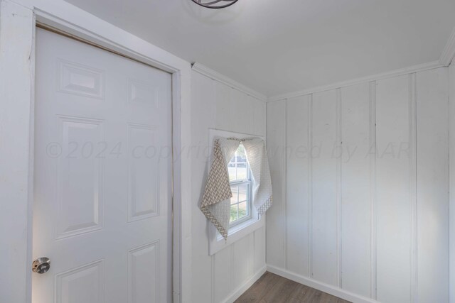 interior space with wood-type flooring and ornamental molding