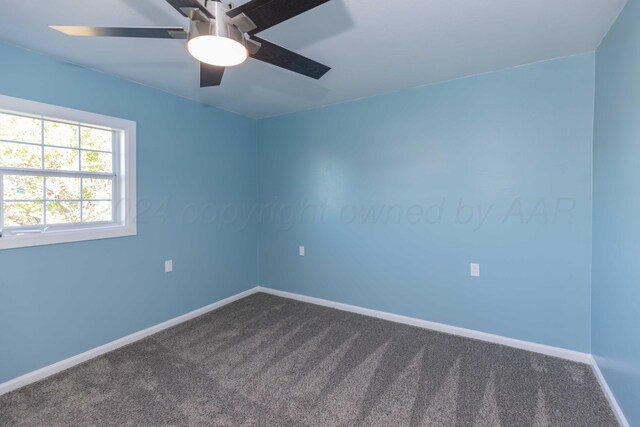 carpeted spare room with ceiling fan