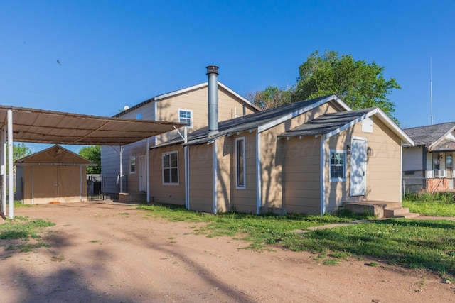 exterior space with a carport and a storage unit