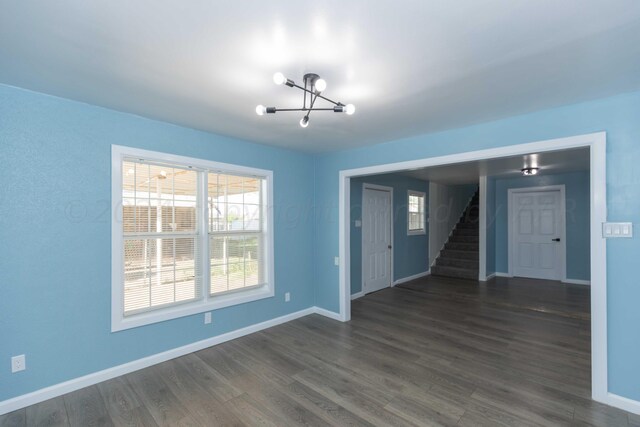 interior space featuring dark hardwood / wood-style flooring and a chandelier