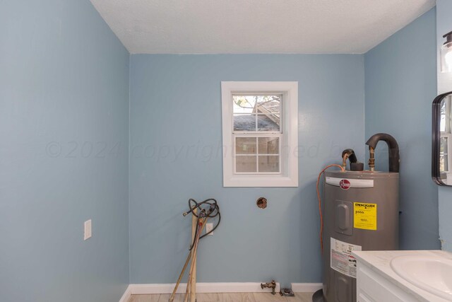 bathroom featuring a textured ceiling and electric water heater