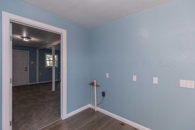 laundry room with dark wood-type flooring