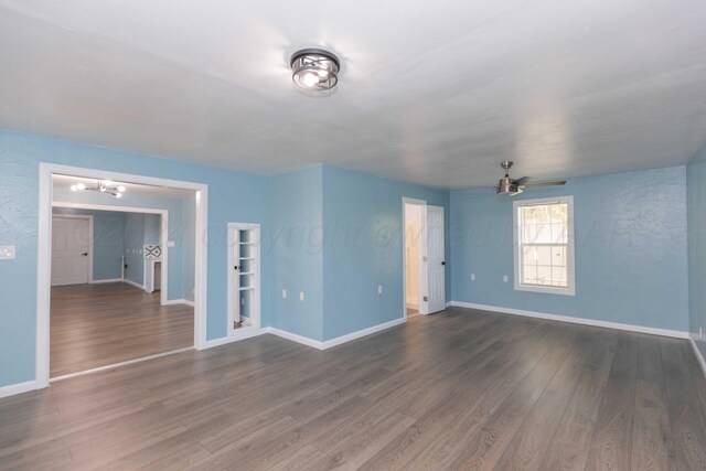 unfurnished room featuring dark hardwood / wood-style flooring and ceiling fan