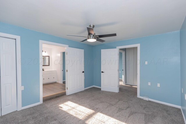 unfurnished bedroom with ceiling fan, connected bathroom, and carpet flooring