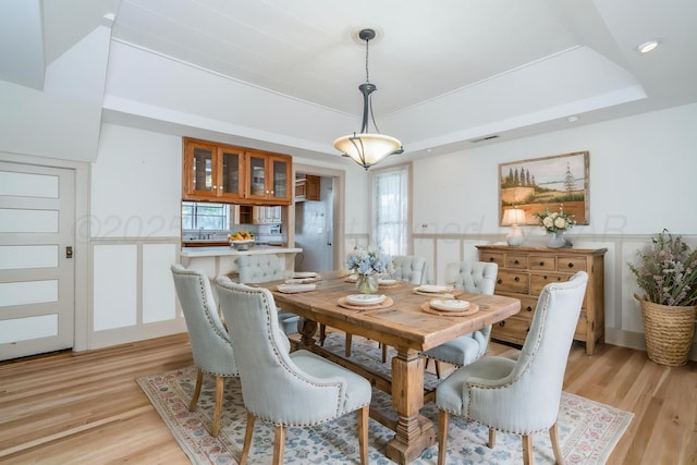 2523 5th Ave, Canyon, TX 79015 - dining room featuring light wood-type flooring, a tray ceiling, and healthy amount of natural light