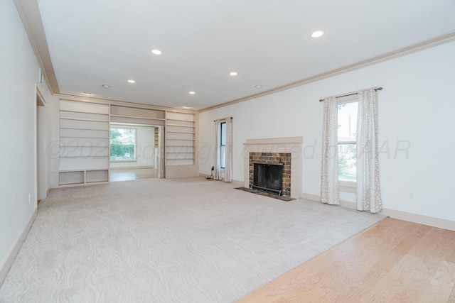 2523 5th Ave, Canyon, TX 79015 - unfurnished living room featuring crown molding, recessed lighting, baseboards, a brick fireplace, and built in shelves