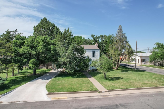 2523 5th Ave, Canyon, TX 79015 - obstructed view of property with a chimney, a front lawn, and concrete driveway