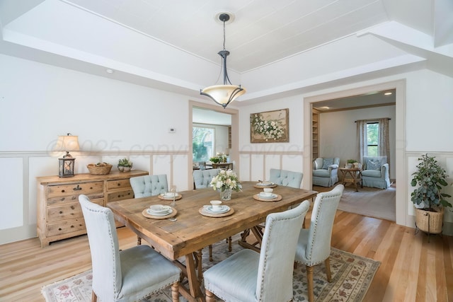 2523 5th Ave, Canyon, TX 79015 - dining space featuring light wood-style flooring, a wainscoted wall, and a decorative wall
