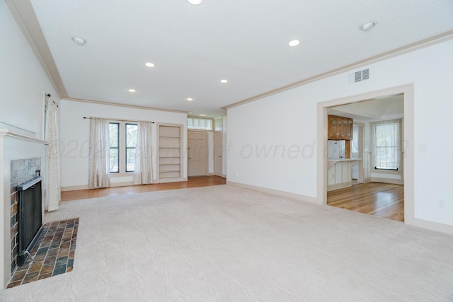 2523 5th Ave, Canyon, TX 79015 - unfurnished living room featuring recessed lighting, crown molding, carpet floors, a tile fireplace, and baseboards