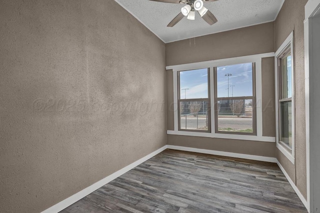 1610 N Hayes St, Amarillo, TX 79107 - unfurnished room with a textured ceiling, dark wood-type flooring, a ceiling fan, and a textured wall