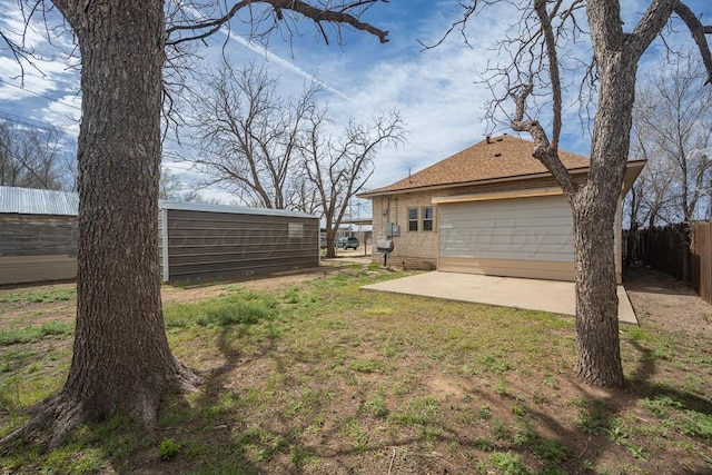 1610 N Hayes St, Amarillo, TX 79107 - view of yard featuring a patio area, fence, and a garage