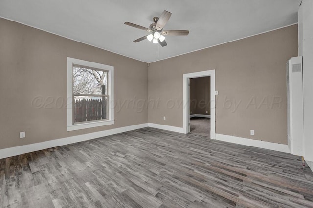 1610 N Hayes St, Amarillo, TX 79107 - empty room featuring baseboards, a ceiling fan, and wood finished floors