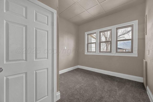 1610 N Hayes St, Amarillo, TX 79107 - unfurnished bedroom featuring a paneled ceiling, baseboards, and dark carpet