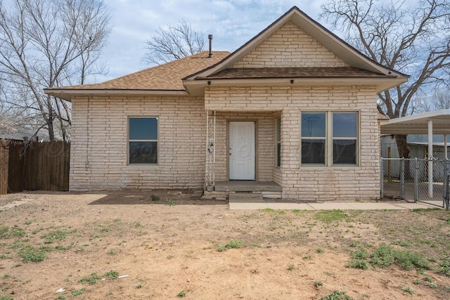 1610 N Hayes St, Amarillo, TX 79107 - view of front of property with a shingled roof, brick siding, fence, and stone siding