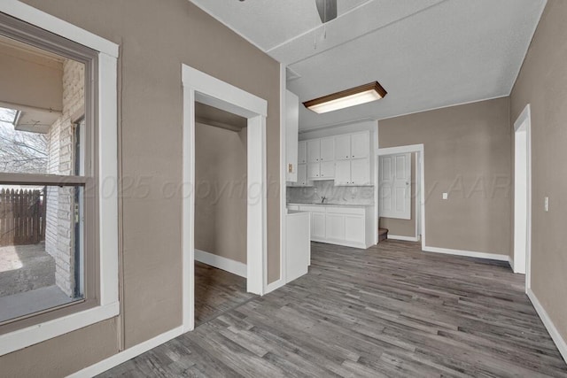 1610 N Hayes St, Amarillo, TX 79107 - unfurnished living room featuring ceiling fan, baseboards, and wood finished floors