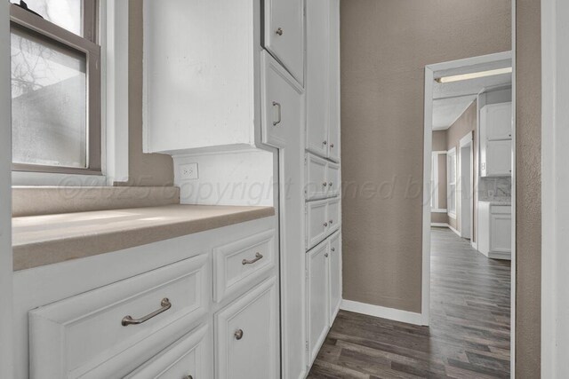 1610 N Hayes St, Amarillo, TX 79107 - interior space featuring a textured wall, baseboards, and dark wood-style floors