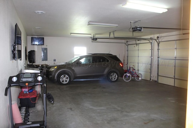 garage featuring electric panel and a garage door opener