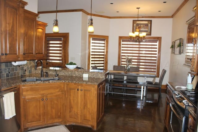 kitchen with a peninsula, a sink, a chandelier, brown cabinetry, and appliances with stainless steel finishes