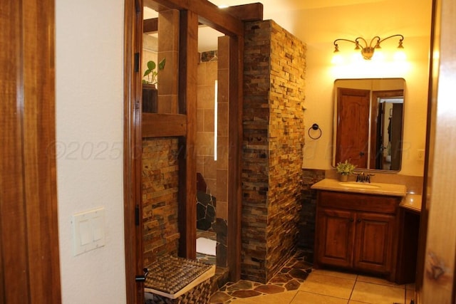 full bath featuring vanity, tile patterned flooring, and a shower stall