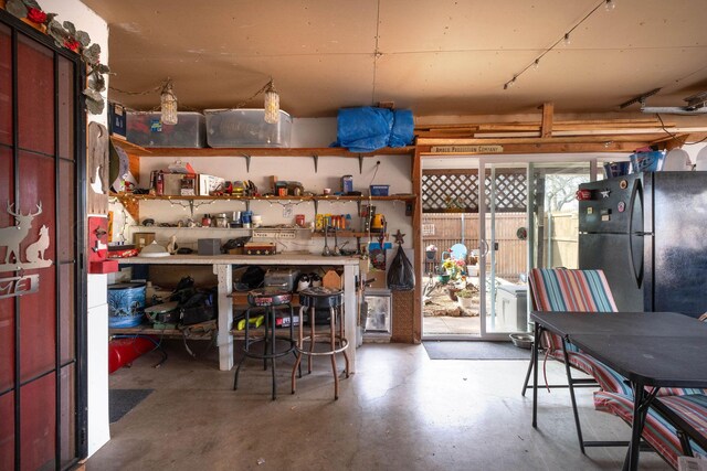 interior space featuring black refrigerator and a workshop area